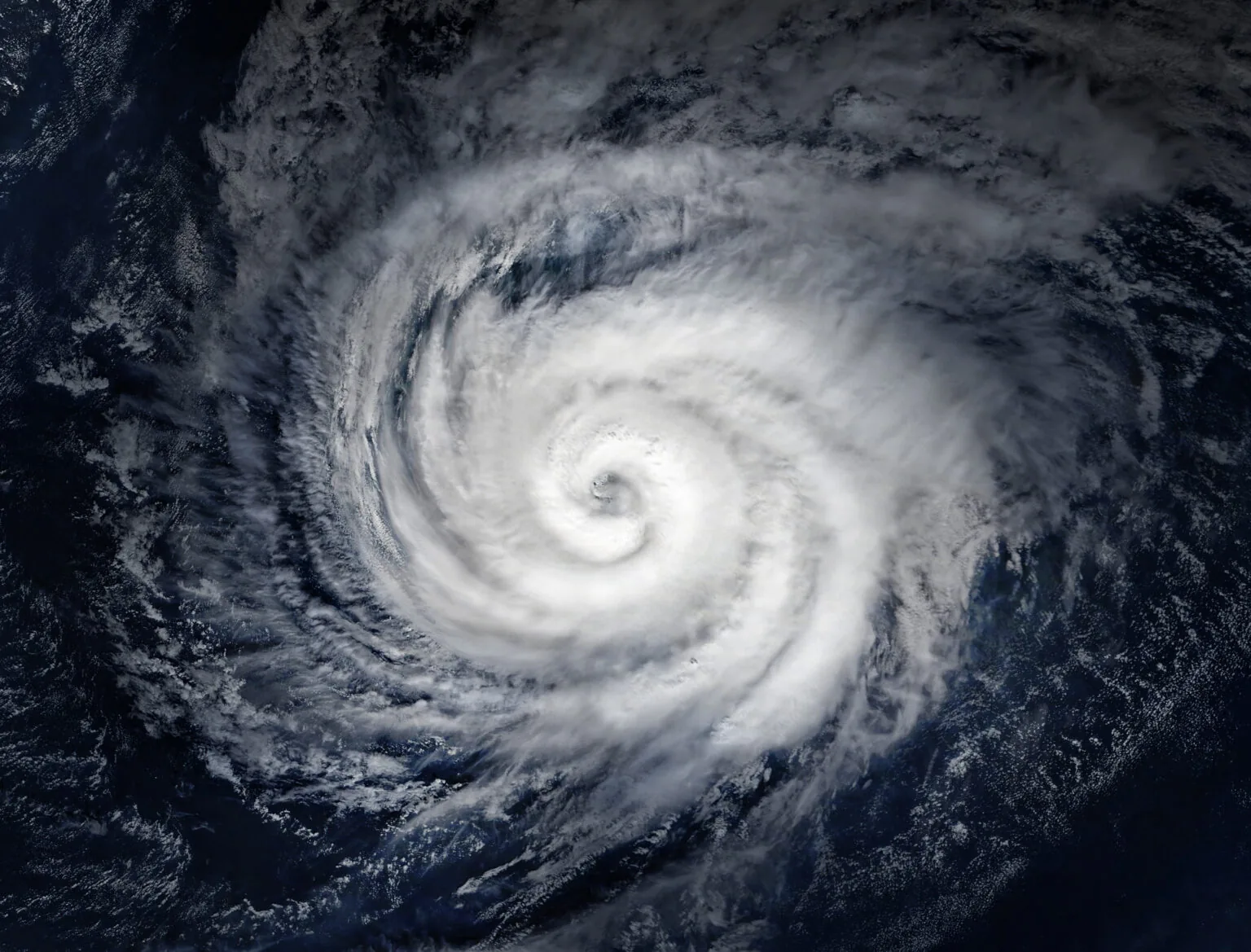 Aerial view of a hurricane. The image is centered over the eye of the storm.